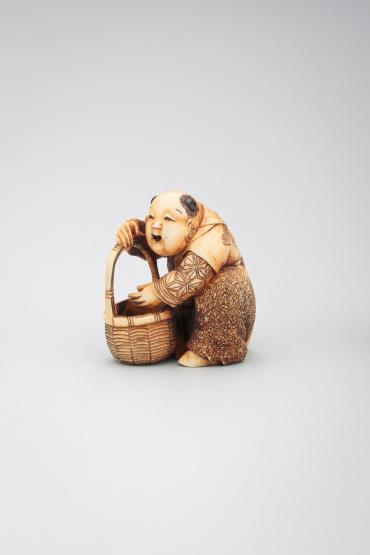 Netsuke: boy with basket