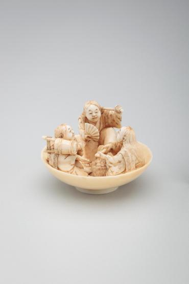 Netsuke: three figures and a tortoise in a sake cup