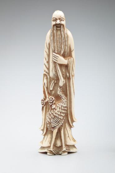 Netsuke: Jurojin, holding blossoming plum-spray