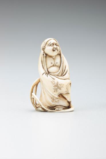 Netsuke: Daruma standing on reed