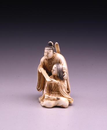 Netsuke: court lady and gentleman with a poem card