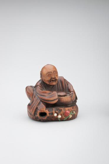 Netsuke: householder with basket of beans excorcizing devils at the Festival of Oni Yarai