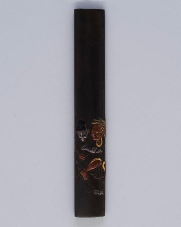 Kozuka: (front) Two Figures; (back) signature and seal (kakihan) on a textured surface