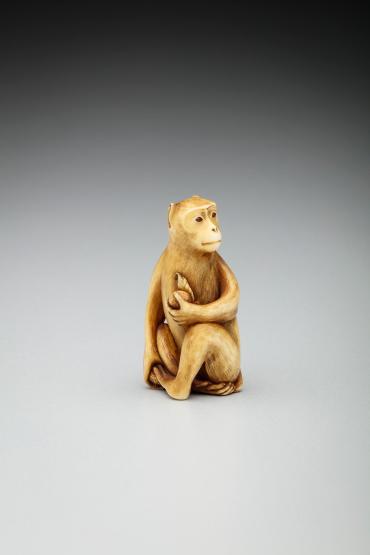 Seated Monkey Holding a Peach