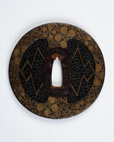 Sword Guard (Tsuba):  Floral Scroll Surrounding Imitation Leather