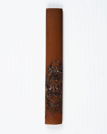 Kozuka: (front) Two Fools; (back) signature on a textured ground