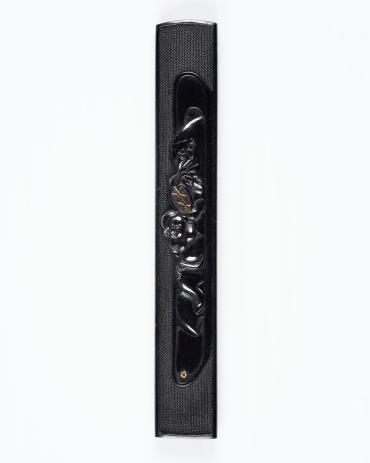 Kozuka: (front) Hotei; (back) incised inscription