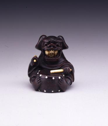 Netsuke: Masked Child Beating a Drum