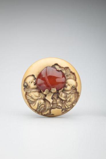 Netsuke: Three karako with peach seed