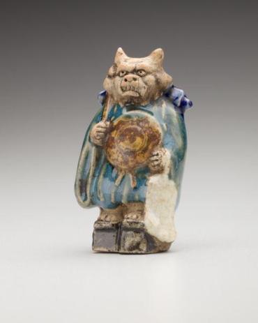 Netsuke: Oni chanting prayers