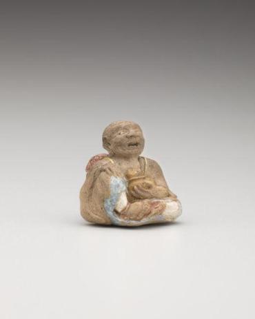 Netsuke: Seated man with basket and cat