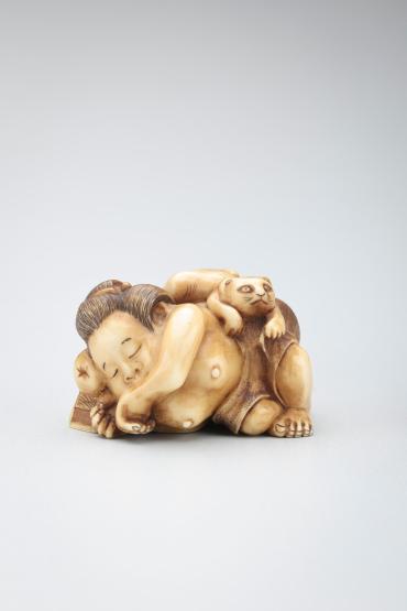 Netsuke: Okame (Goddess of Mirth) sleeping with a cat