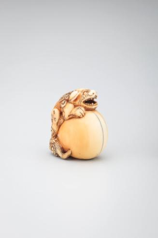 Netsuke: lion-dog with large ball