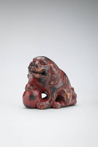 Netsuke:  male lion with a ball