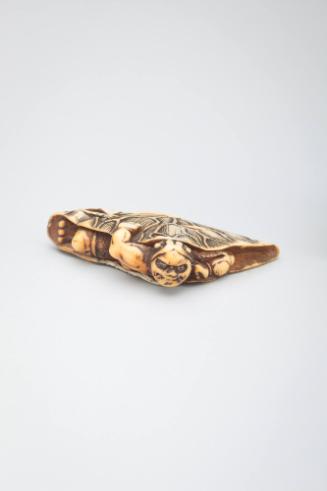 Netsuke: demon caught in a lotus leaf