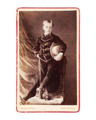 Portrait of a Young Boy in a Velvet Suit Holding a Straw Hat