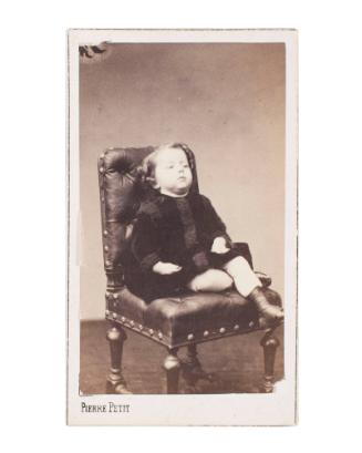 Untitled (portrait of a child sitting on a chair)