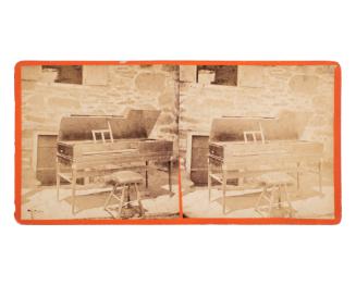 Piano-forte (?) next to masonry (faced stone) wall