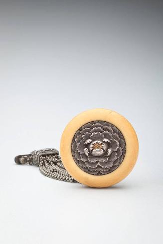 Netsuke: Chyrsanthemum kagamibuta with metal himo that has 12 chains