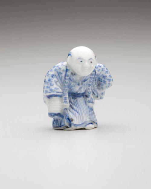 Netsuke: Man in kimono holding a lantern