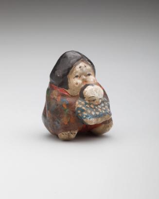 Netsuke: Amorous Okame holding a baby