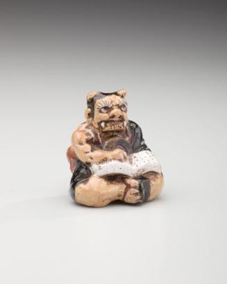 Netsuke: Oni reading Buddhist sutras