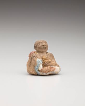 Netsuke: Seated man with basket and cat