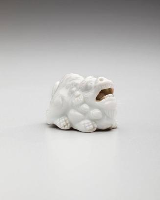 Netsuke: Crouching shishi lion with loose ceramic bead in mouth