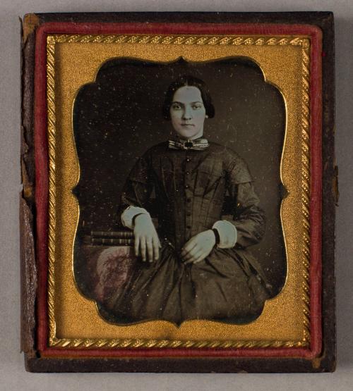 Portrait of a Young Woman Beside a Table with Two Books